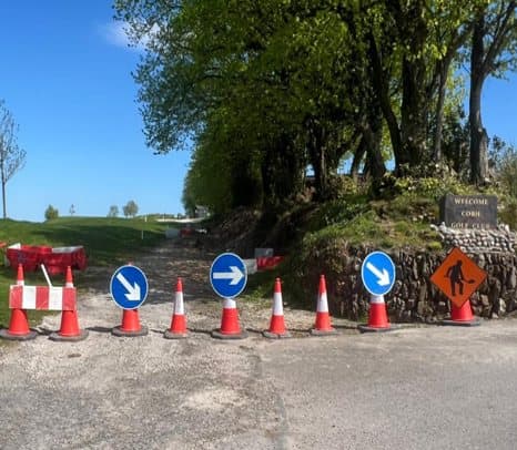 Traffic management signs and cones at the golf course entrance