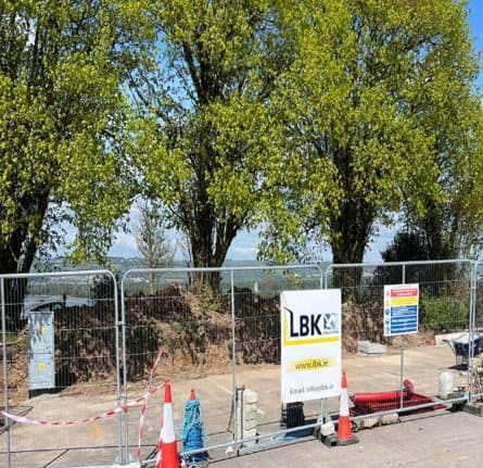 Fenced work area with LBK Solutions site signage