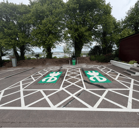 Completed dual EV charging bays with line marking and charge point