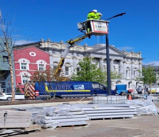 LBK engineer in a cherry picker fitting a lantern to a new column on Morrisons Island, Cork